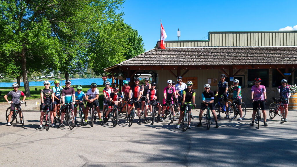 Image of a group of road bikers posing before their ride.